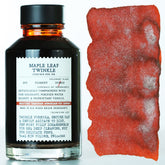 Bottle of Maple Leaf Twinkle fountain pen ink with a sample swatch on a white background